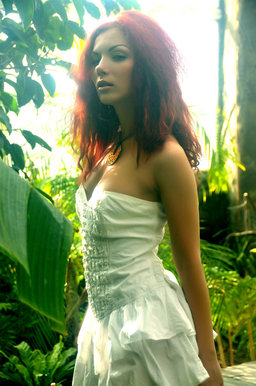 A redhead nymph slowly strips off her dainty dress from Erotic Beauty