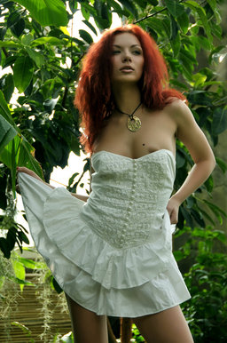 A redhead nymph slowly strips off her dainty dress from Erotic Beauty