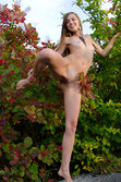 A smiling and confident Sofy frolics among the grass from Met-Art